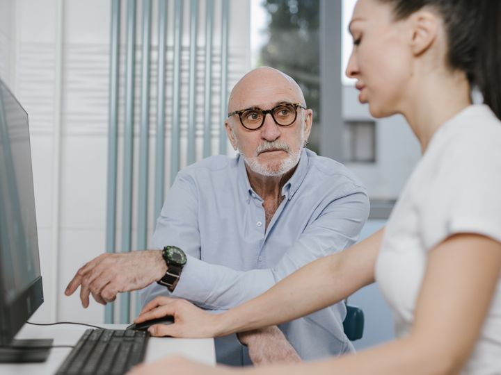 Paciente mayor revisando sus resultados con una profesional de salud